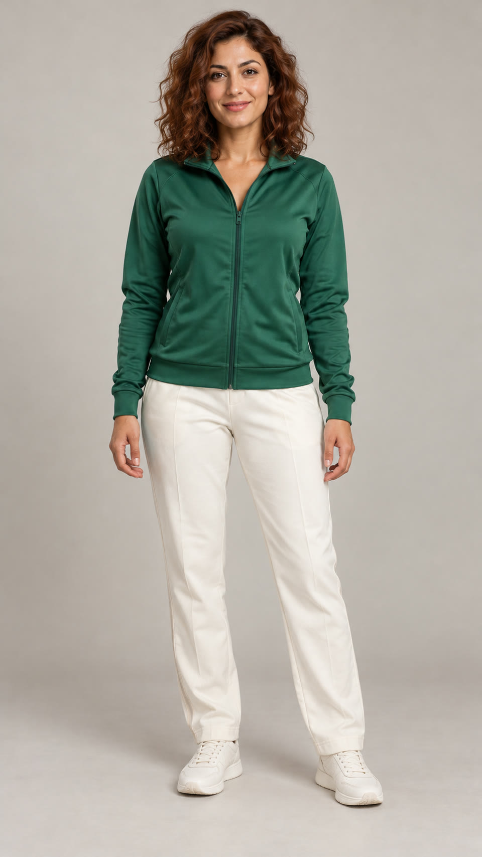 AI-generated adult woman with auburn curls, emerald track jacket and ivory trousers