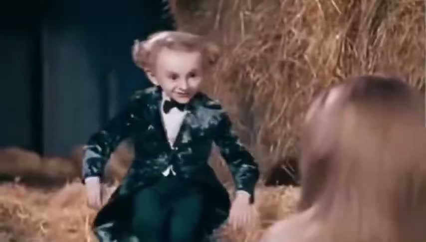Source frame with the dark-coated Rumpelstiltskin character dancing in the barn